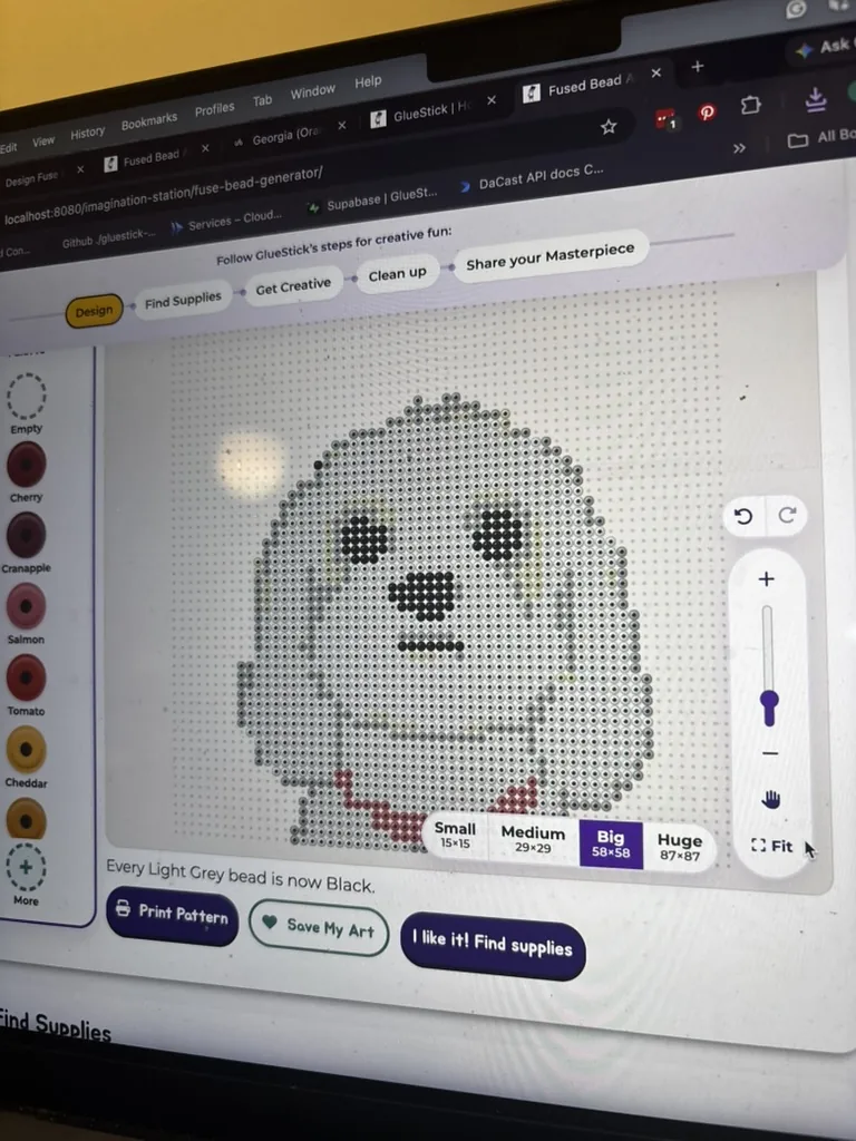 A laptop showing a fuse bead pattern of a dog made in GlueStick